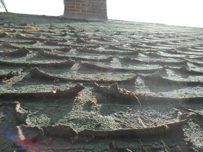 Roof with curling shingles